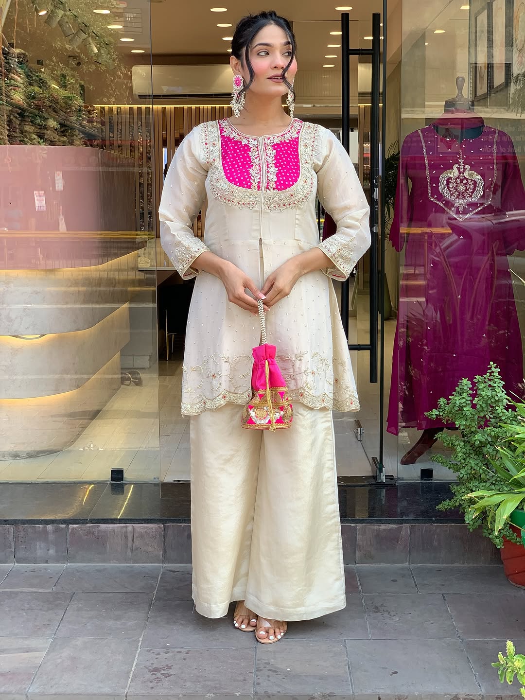 Elevate your ethnic style with this elegant cream kurti set featuring intricate embroidery and a striking purple yoke. Paired with flared pants, this outfit blends tradition with modern flair—perfect for festive occasions or graceful daywear.