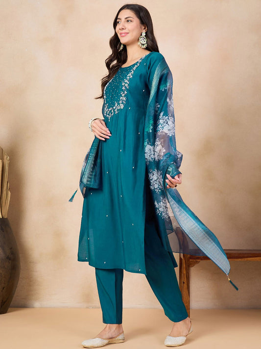 Step into elegance with this teal blue kurti set, adorned with intricate embroidery and a beautifully printed dupatta. The rich color and delicate detailing make it a perfect choice for festive occasions and gatherings.