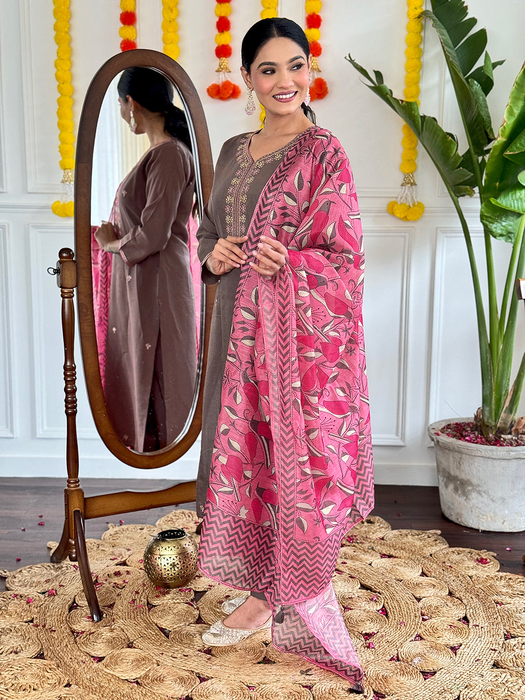 This elegant brown kurti set is a perfect blend of simplicity and sophistication. Featuring delicate embroidery on the neckline and a contrasting pink floral dupatta