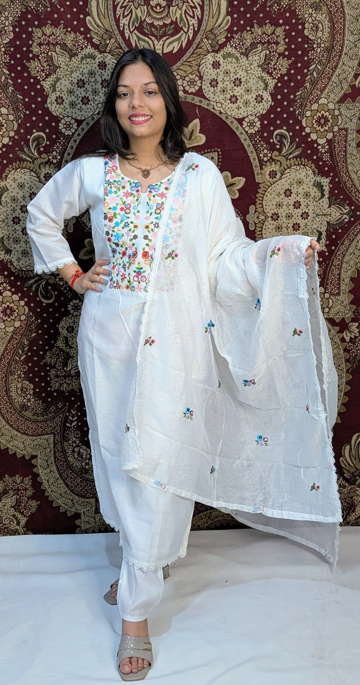Elevate your elegance with this pristine white kurti set, featuring exquisite multicolor embroidery on the neckline