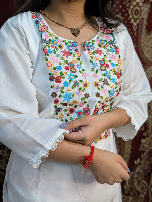 Elevate your elegance with this pristine white kurti set, featuring exquisite multicolor embroidery on the neckline