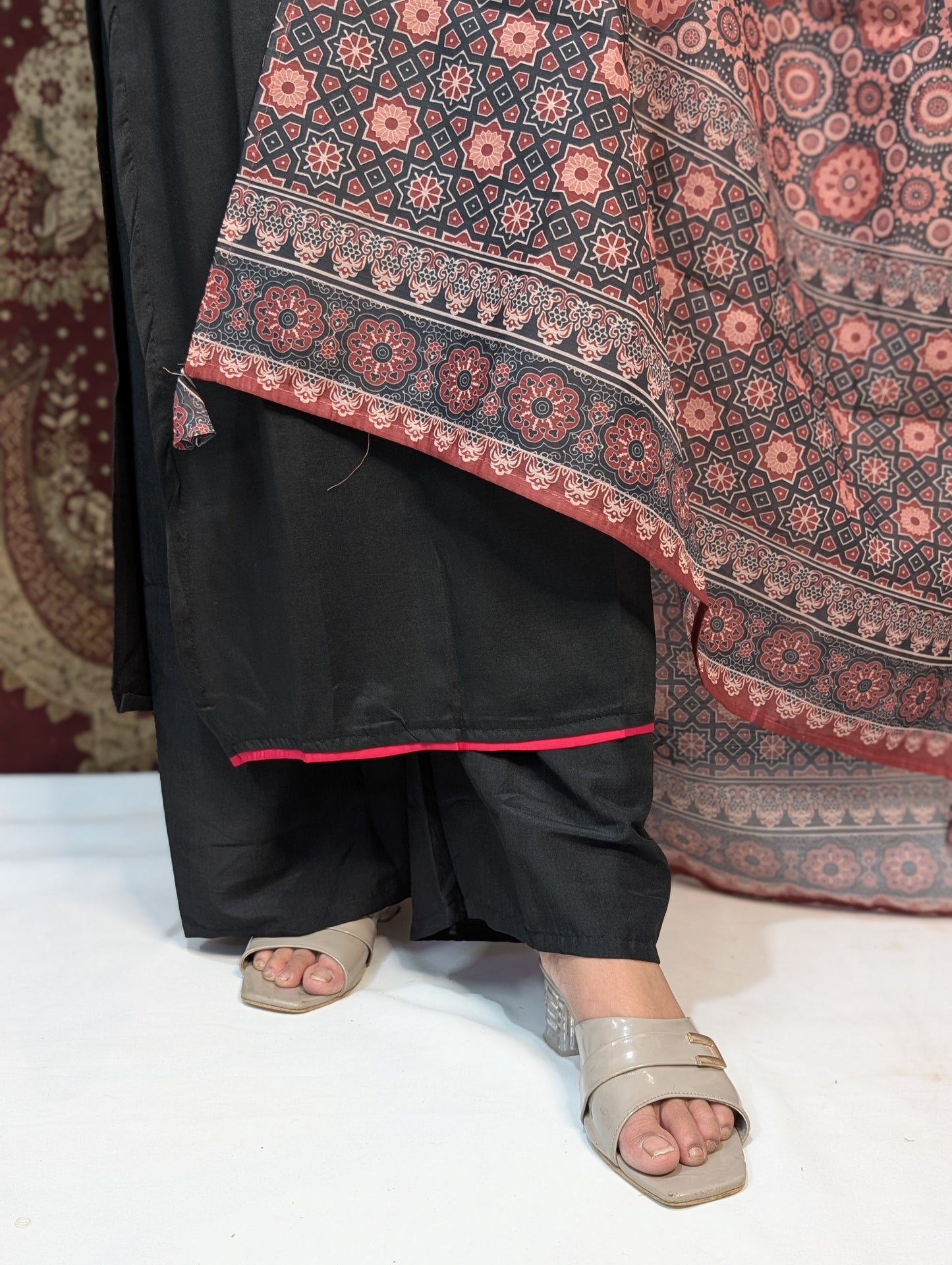 Exude elegance in this black kurti set, highlighted by intricate embroidery around the neckline and a beautifully printed dupatta in earthy tones. A perfect pick for graceful gatherings, this ensemble brings together simplicity and sophistication.