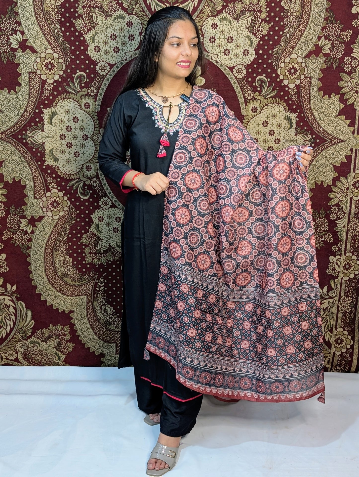 Exude elegance in this black kurti set, highlighted by intricate embroidery around the neckline and a beautifully printed dupatta in earthy tones. A perfect pick for graceful gatherings, this ensemble brings together simplicity and sophistication.