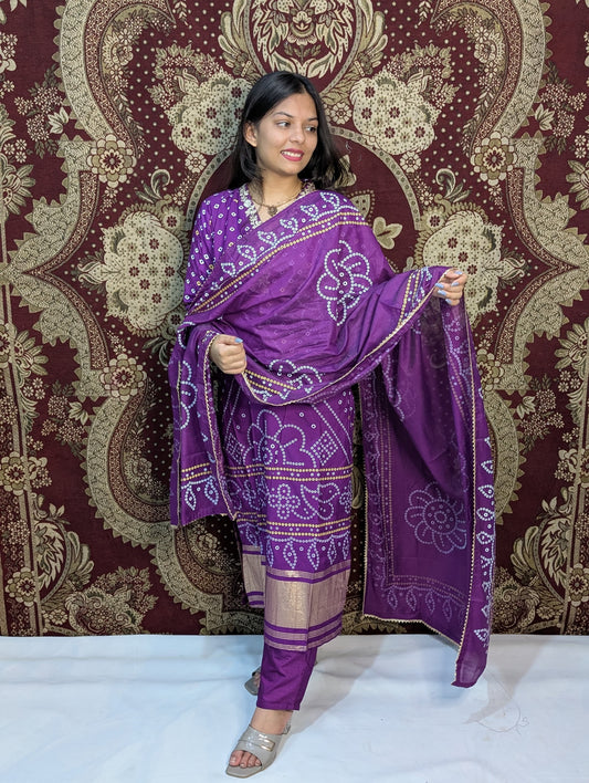 Step into elegance with this stunning purple Bandhani kurti set, adorned with intricate traditional patterns and golden detailing. Perfect for festive occasions or cultural celebrations, it beautifully blends heritage with modern style for a timeless look