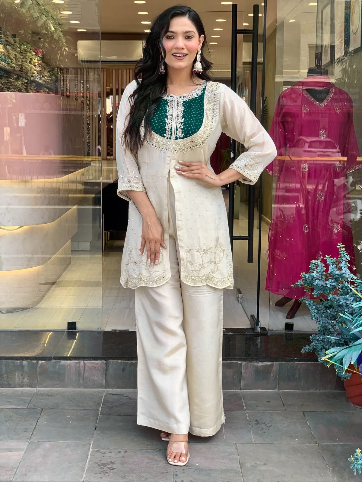 Elevate your ethnic style with this elegant cream kurti set featuring intricate embroidery and a striking purple yoke. Paired with flared pants, this outfit blends tradition with modern flair—perfect for festive occasions or graceful daywear.