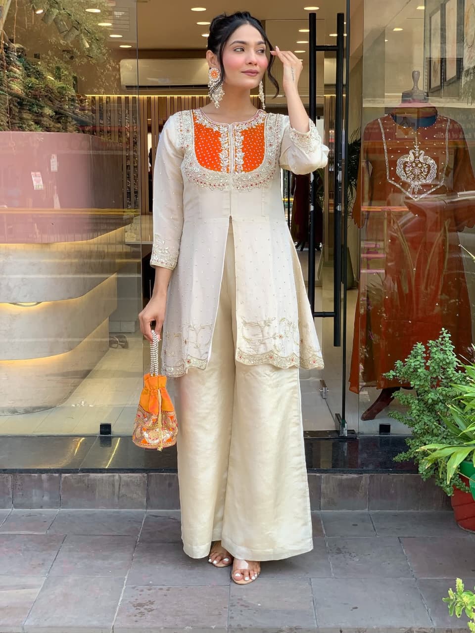 Elevate your ethnic style with this elegant cream kurti set featuring intricate embroidery and a striking purple yoke. Paired with flared pants, this outfit blends tradition with modern flair—perfect for festive occasions or graceful daywear.