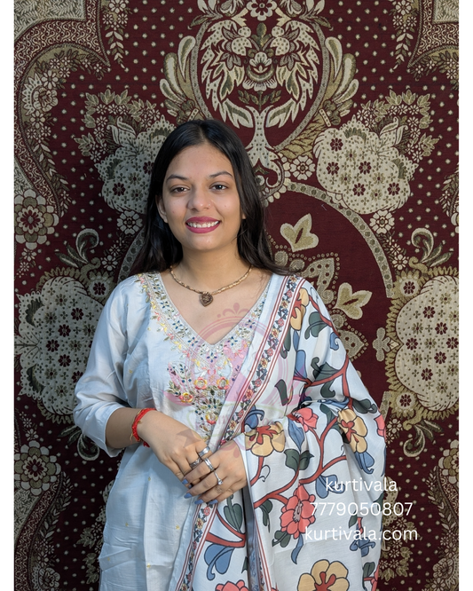 This soft pastel kurti set brings grace and charm with delicate embroidery on the neckline and a vibrant floral dupatta with golden zari borders. Ideal for festive wear or special occasions, it blends elegance with comfort effortlessly