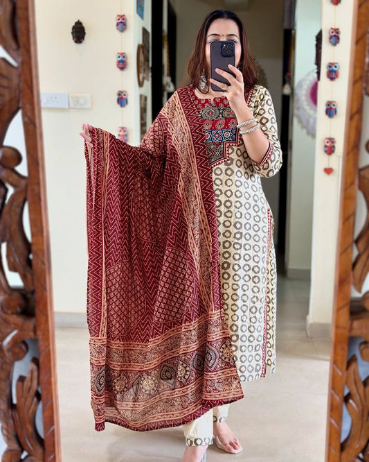 Elevate your ethnic wardrobe with this elegant beige kurti set featuring intricate Ajrakh embroidery on the yoke and sleeves. Paired with matching straight pants and a rich red dupatta, it offers timeless grace for festive and casual wear alike