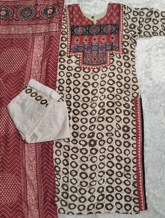Elevate your ethnic wardrobe with this elegant beige kurti set featuring intricate Ajrakh embroidery on the yoke and sleeves. Paired with matching straight pants and a rich red dupatta, it offers timeless grace for festive and casual wear alike