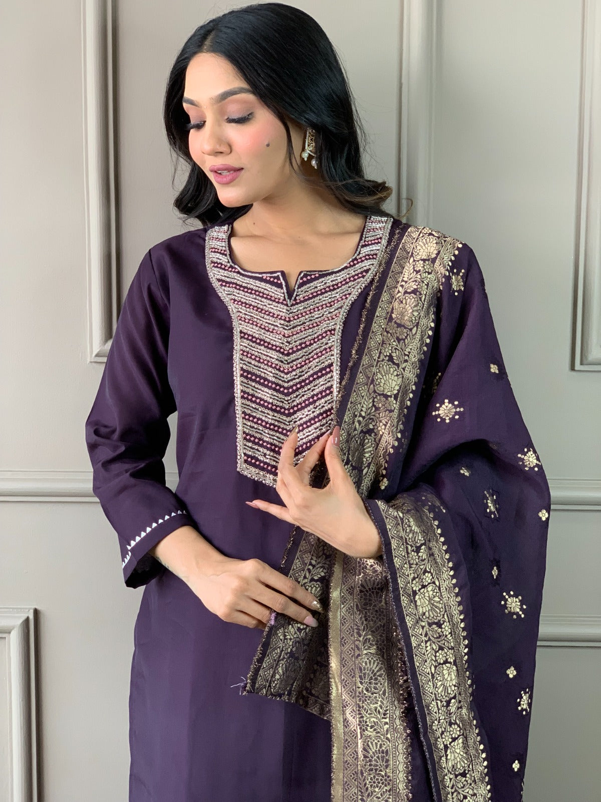 Exude elegance in this deep plum kurti set, featuring exquisite embroidery and a rich gold-detailed dupatta