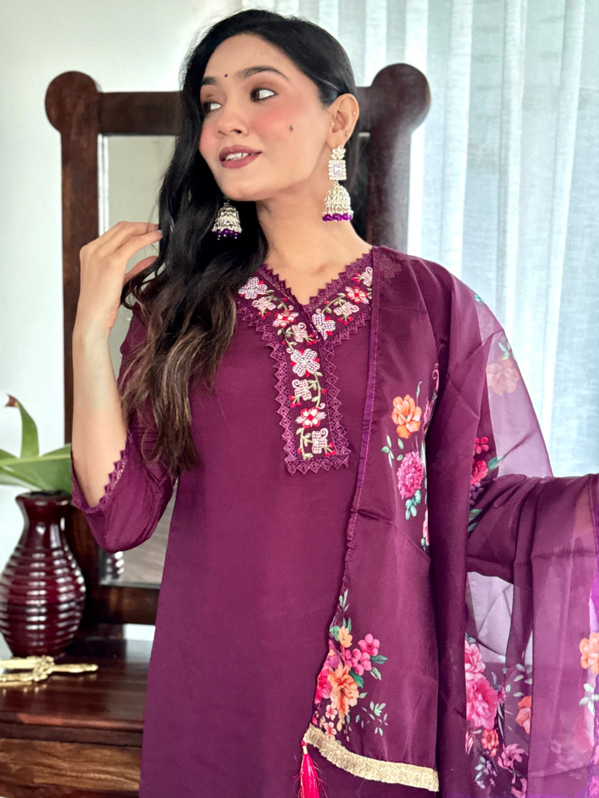 Embrace elegance with this rich plum kurti set, featuring intricate lace detailing and vibrant floral prints