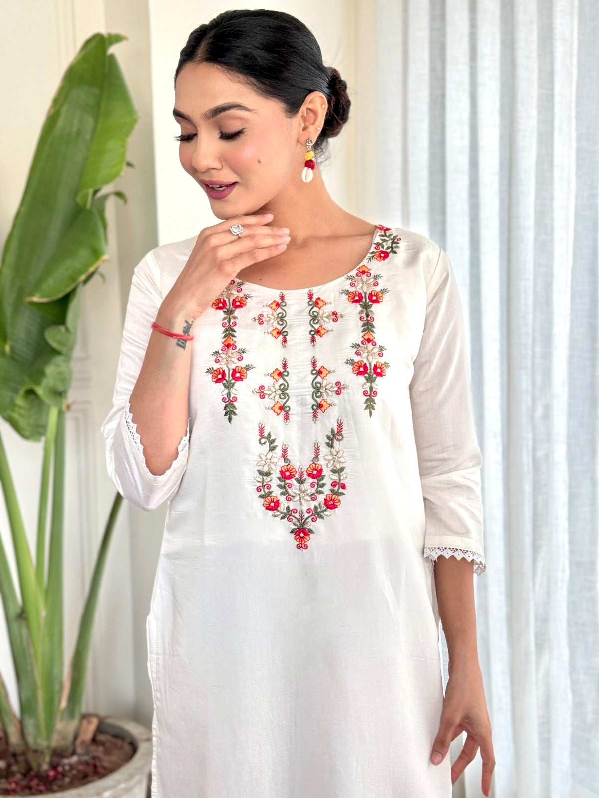 Step into elegance with this pristine white kurti set, beautifully adorned with delicate floral embroidery