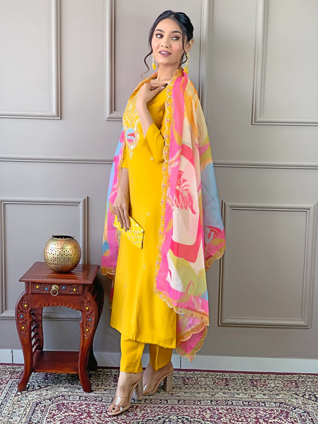 Brighten up your wardrobe with this radiant yellow kurti set, featuring delicate embroidery and a vibrant multicolored dupatta