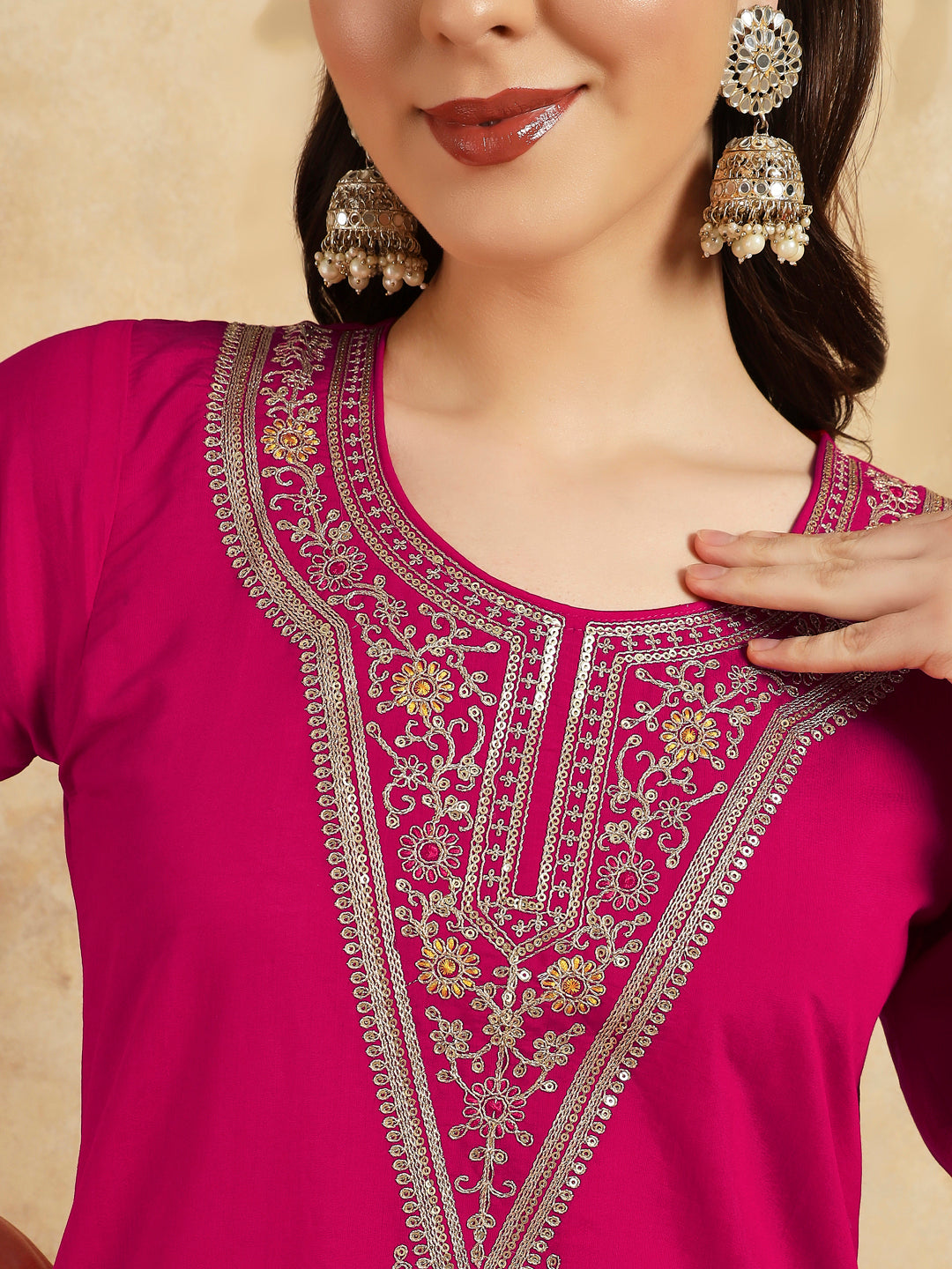 Radiate grace in this stunning magenta kurti set, adorned with intricate embroidery and delicate golden accents
