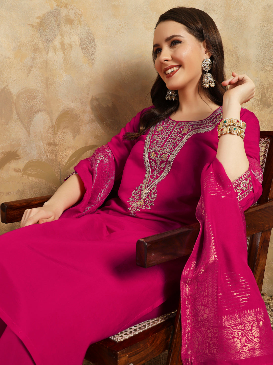 Radiate grace in this stunning magenta kurti set, adorned with intricate embroidery and delicate golden accents