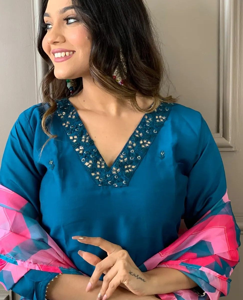 Elevate your style with this elegant blue kurti set, featuring intricate embellishments and a vibrant pink and blue zigzag dupatta