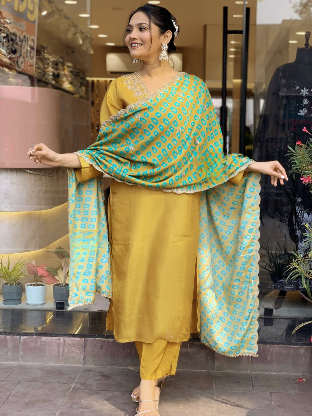 Embrace festive flair with this radiant mustard kurta set featuring delicate embroidery and a striking teal dupatta