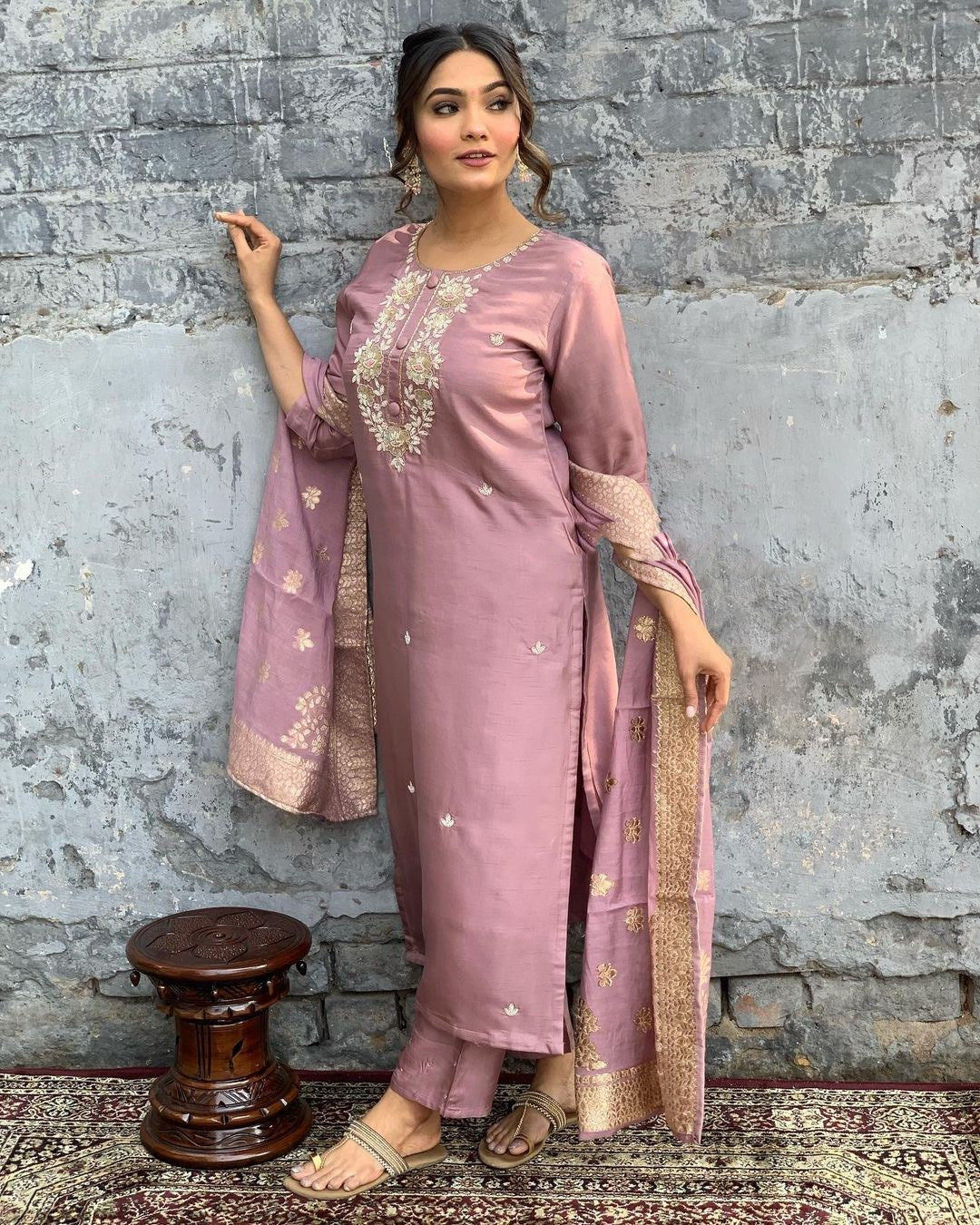 Indulge in sophistication with this subtle mauve kurta set, intricately adorned with gold-toned embroidery