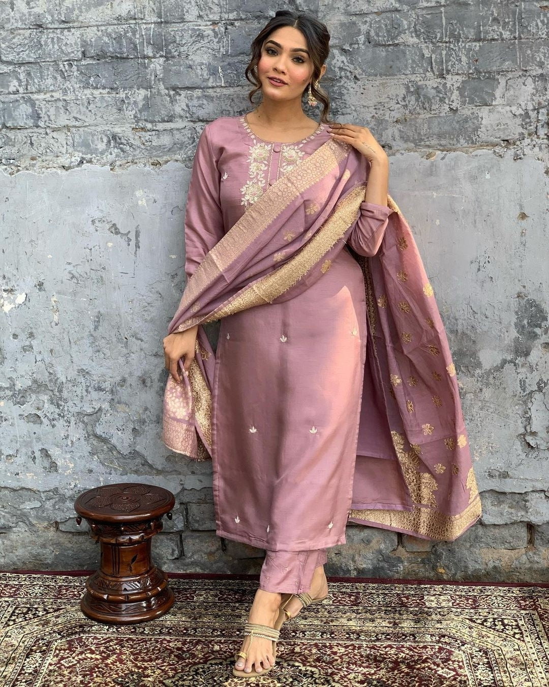Indulge in sophistication with this subtle mauve kurta set, intricately adorned with gold-toned embroidery