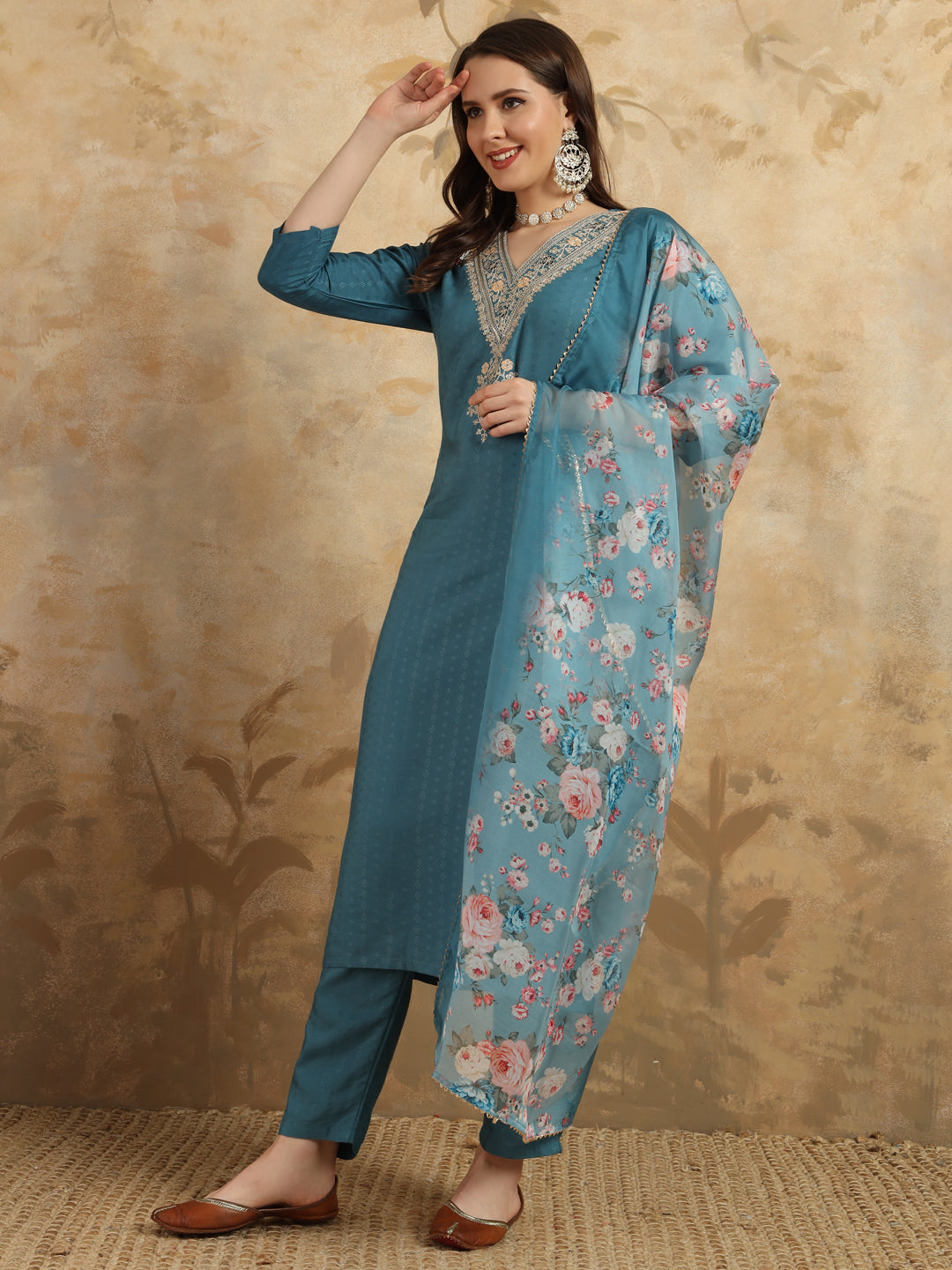 Infuse your wardrobe with elegance in this teal kurta set, showcasing delicate embroidery and a romantic floral dupatta