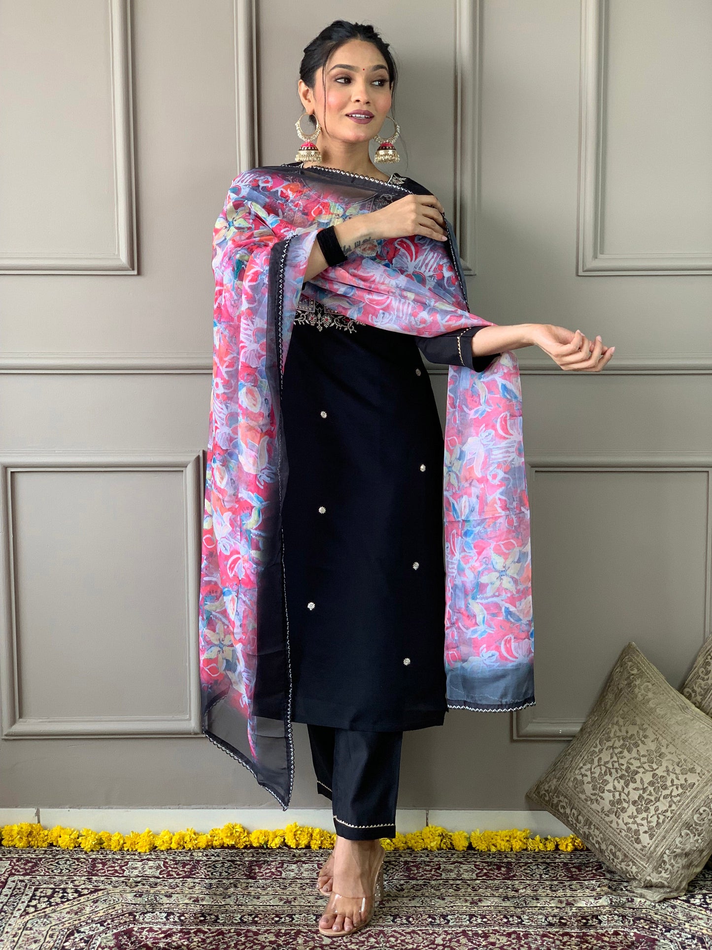 Make a statement with this elegant black kurta set, featuring delicate pearl embellishments and a striking floral dupatta