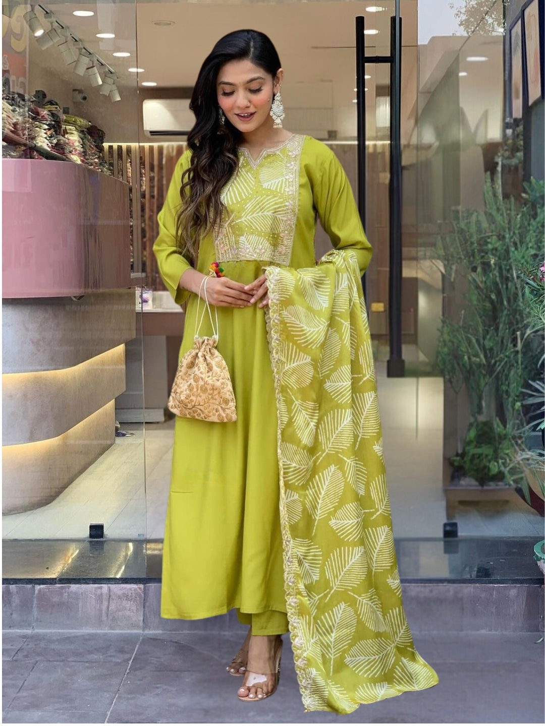Embrace elegance with this refreshing green kurta set, featuring intricate embroidery and a graceful leaf-patterned dupatta