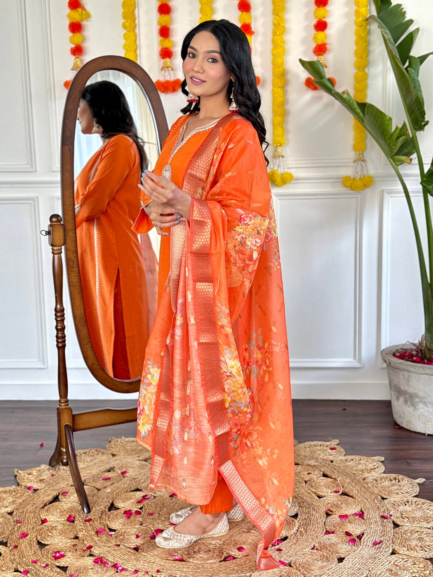 Radiate festive charm in this vibrant orange kurta set, adorned with delicate embroidery and a stunning floral dupatta