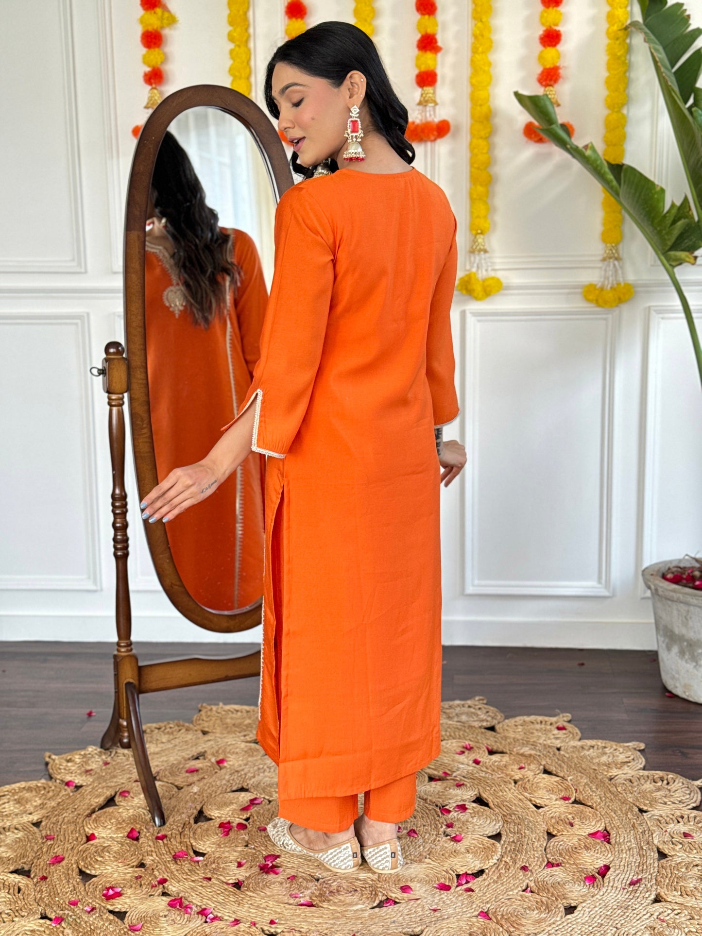 Radiate festive charm in this vibrant orange kurta set, adorned with delicate embroidery and a stunning floral dupatta
