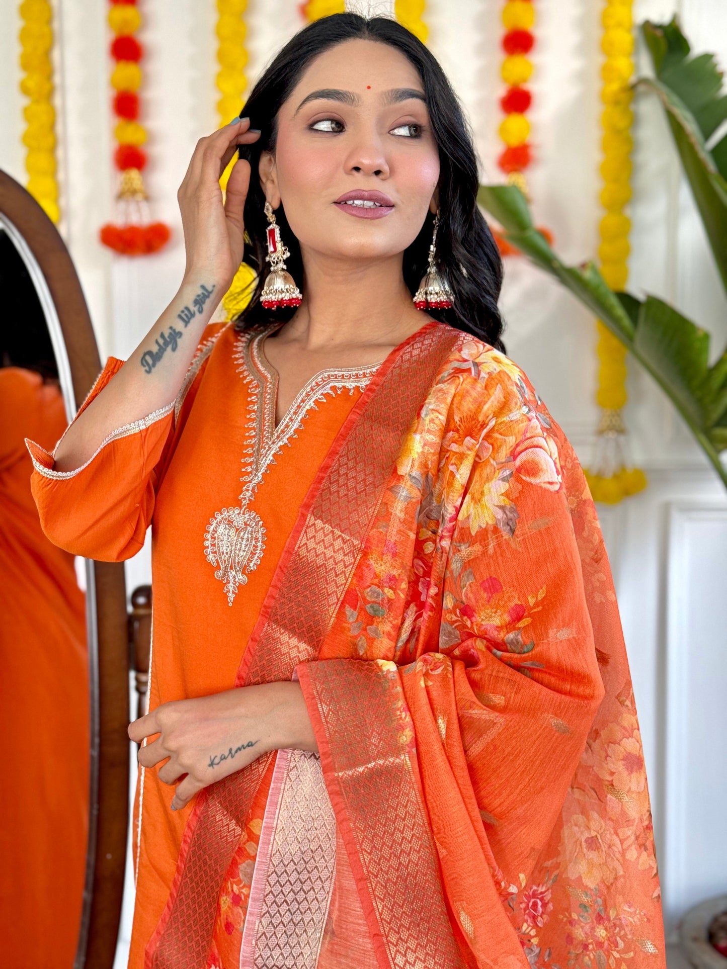 Radiate festive charm in this vibrant orange kurta set, adorned with delicate embroidery and a stunning floral dupatta