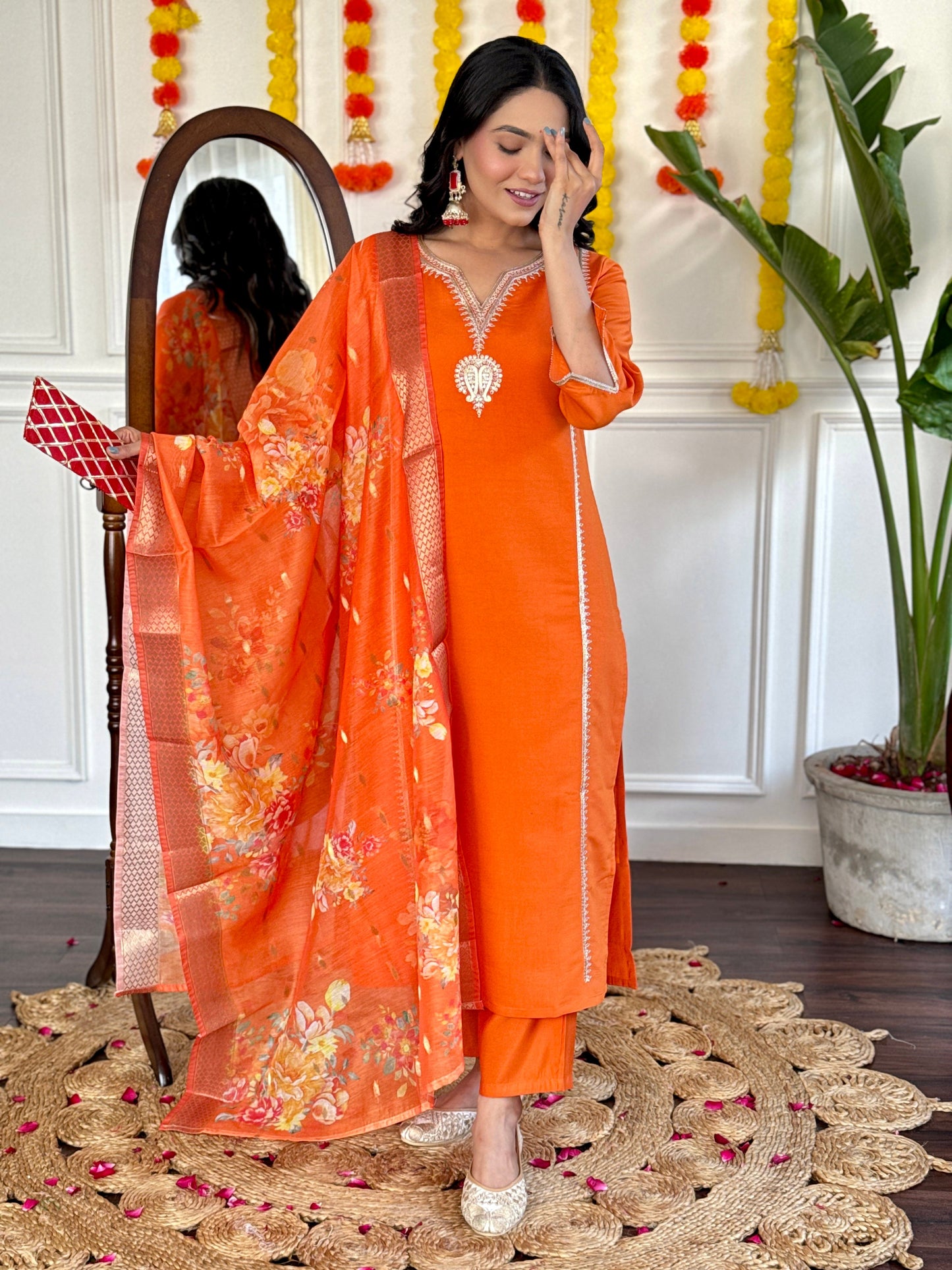 Radiate festive charm in this vibrant orange kurta set, adorned with delicate embroidery and a stunning floral dupatta