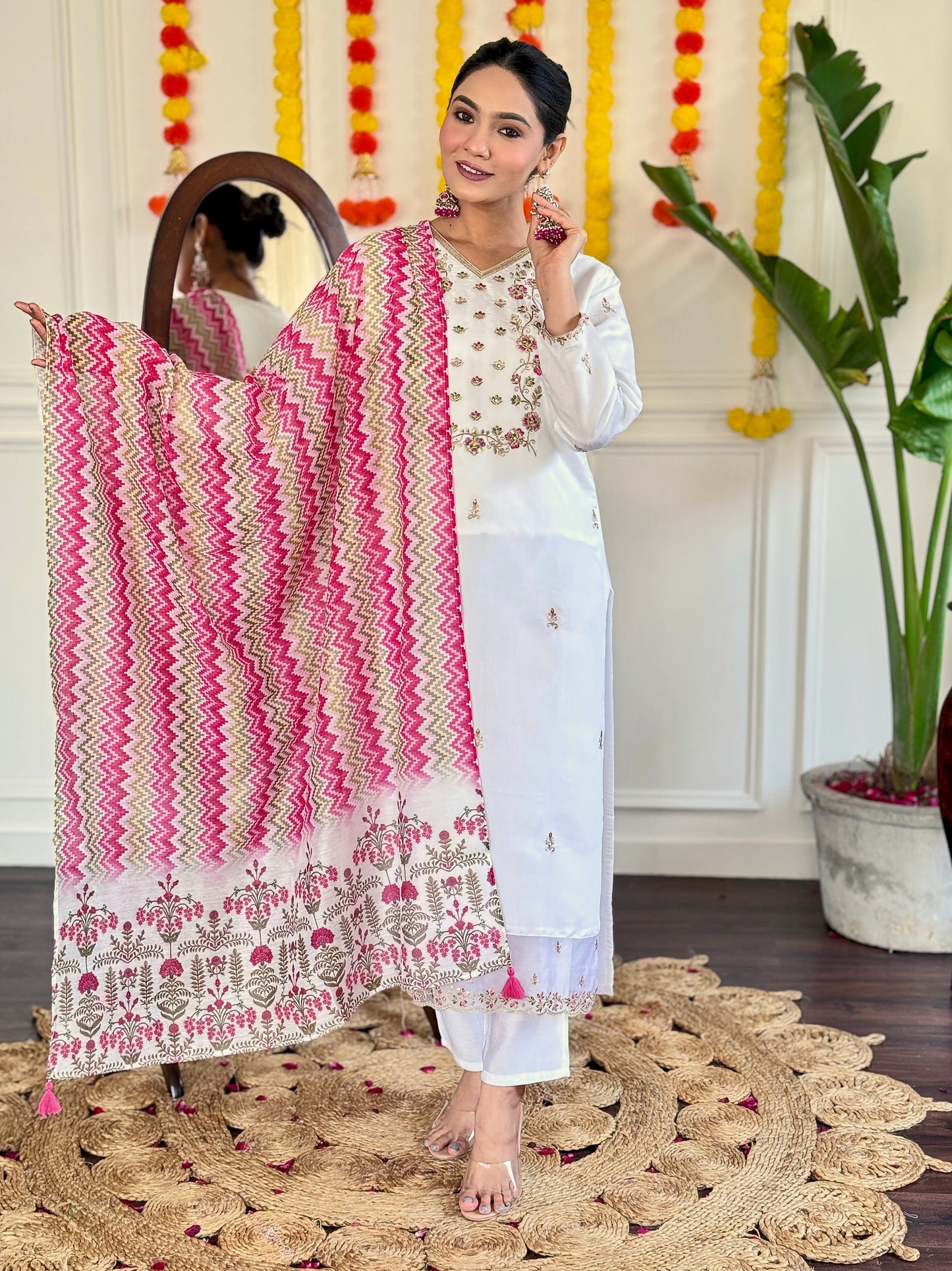 Elevate your style with this elegant white Kurti set, adorned with delicate mirror work and a vibrant pink zigzag dupatta