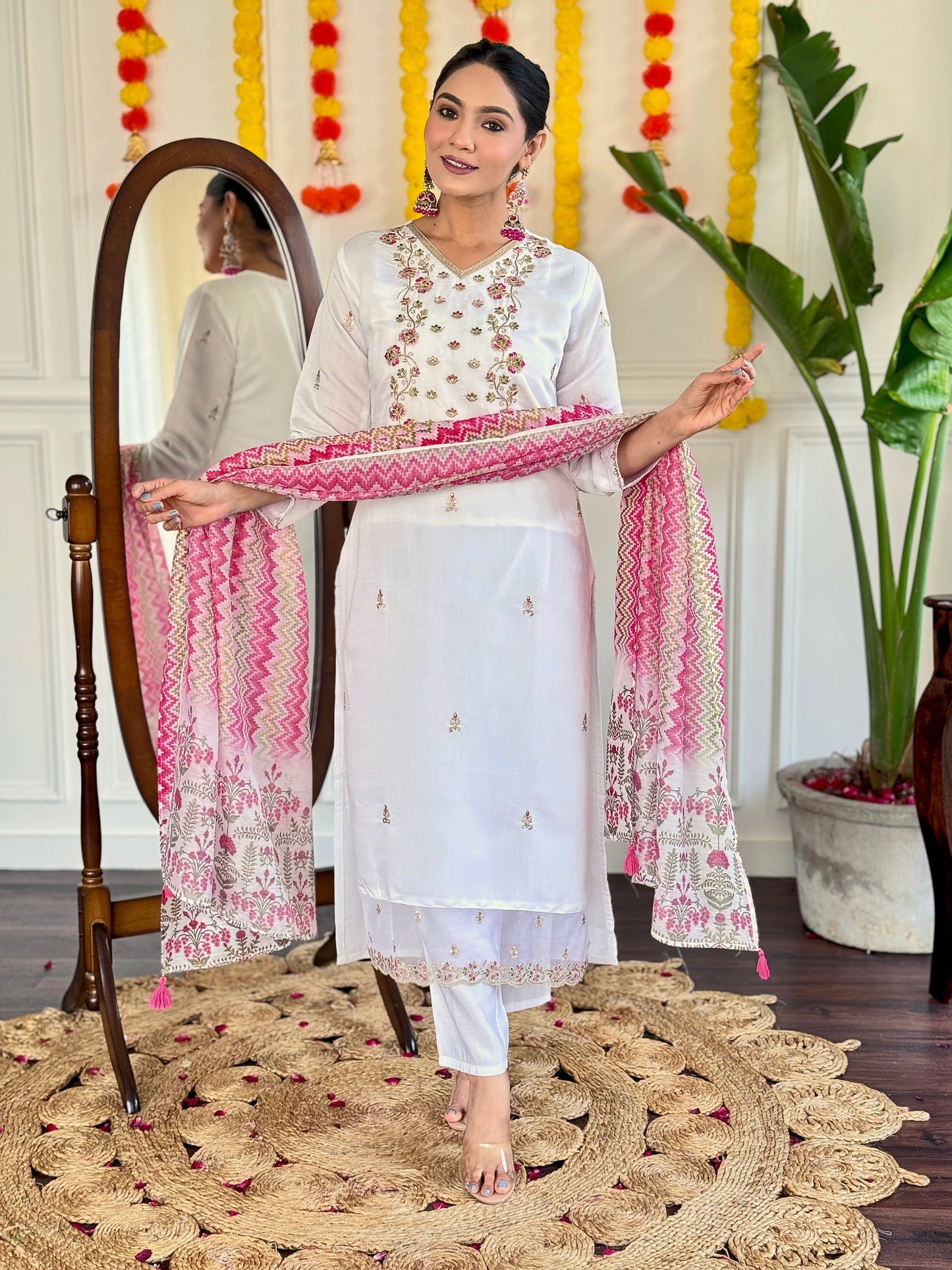 Elevate your style with this elegant white Kurti set, adorned with delicate mirror work and a vibrant pink zigzag dupatta