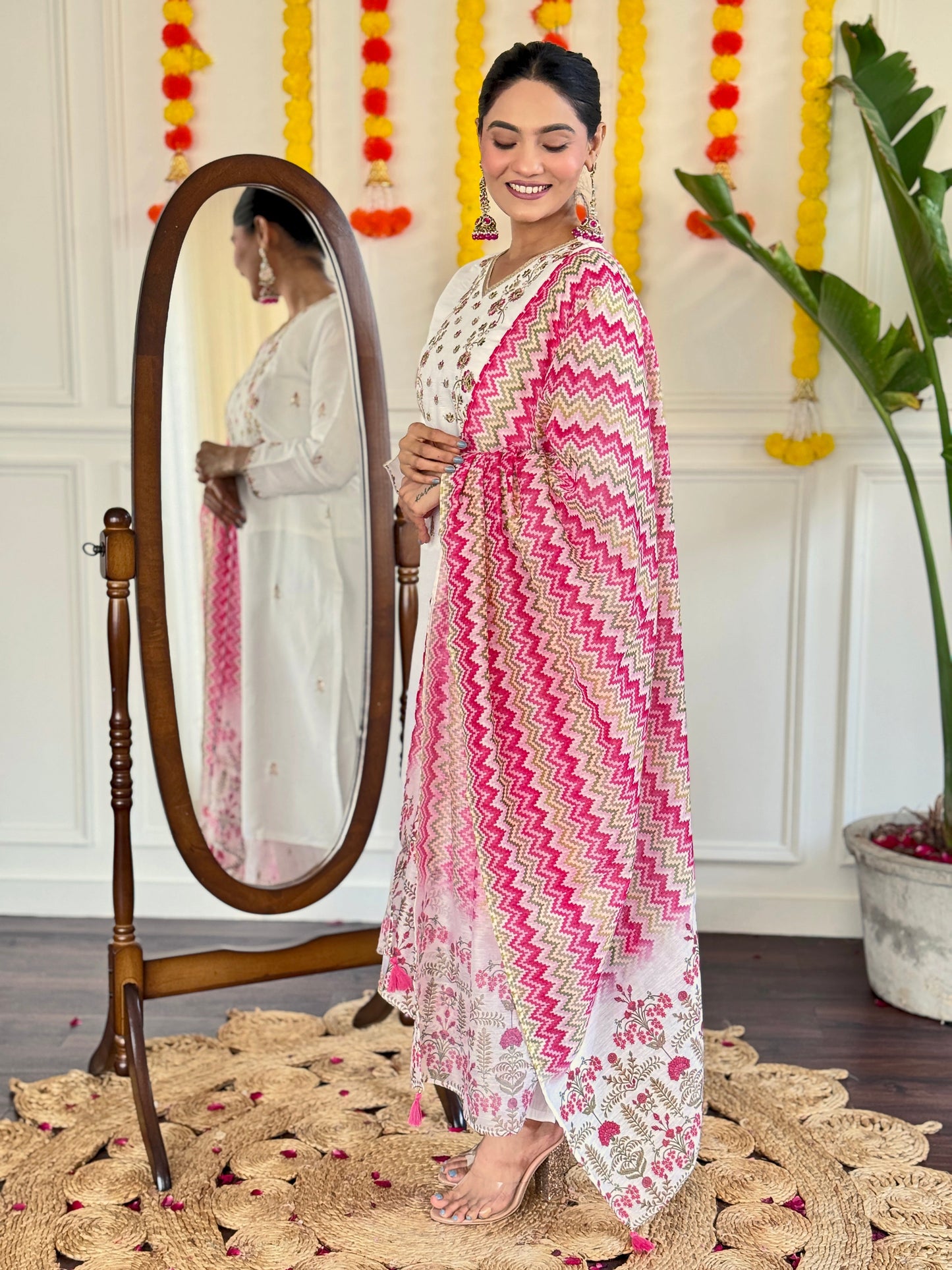 Elevate your style with this elegant white Kurti set, adorned with delicate mirror work and a vibrant pink zigzag dupatta