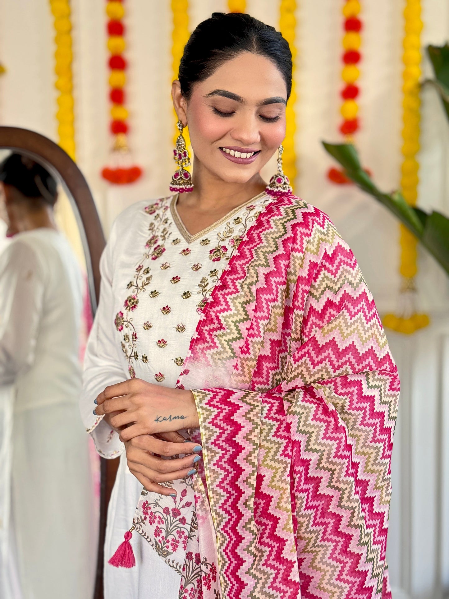 Elevate your style with this elegant white Kurti set, adorned with delicate mirror work and a vibrant pink zigzag dupatta