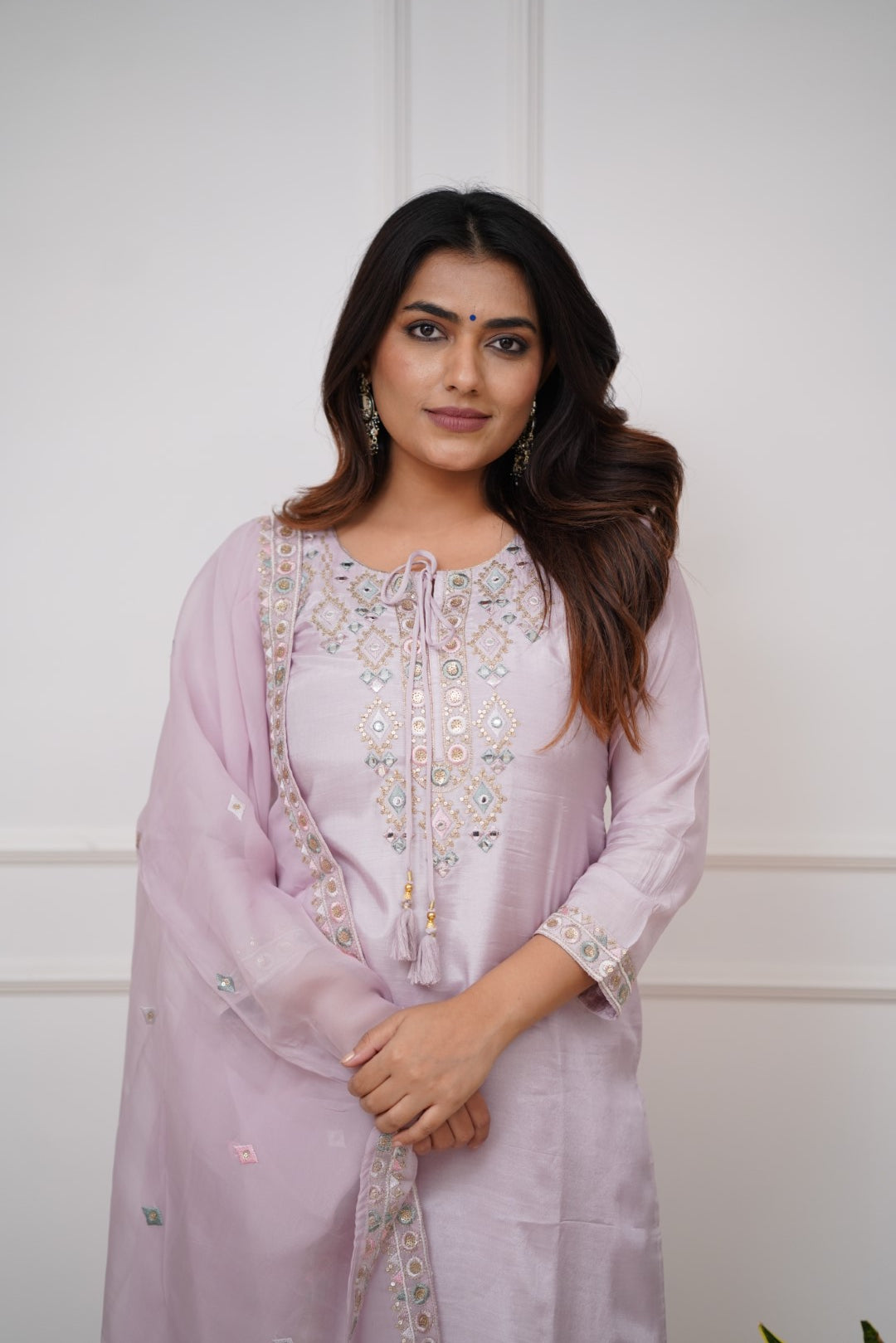 Grace meets elegance in this pastel lavender kurti set, adorned with delicate embroidery and mirror work
