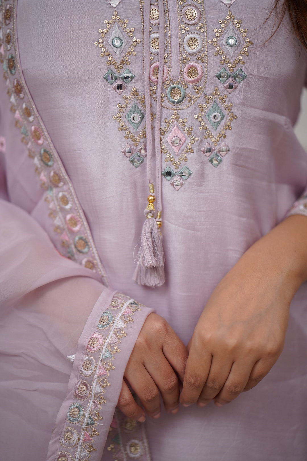 Grace meets elegance in this pastel lavender kurti set, adorned with delicate embroidery and mirror work