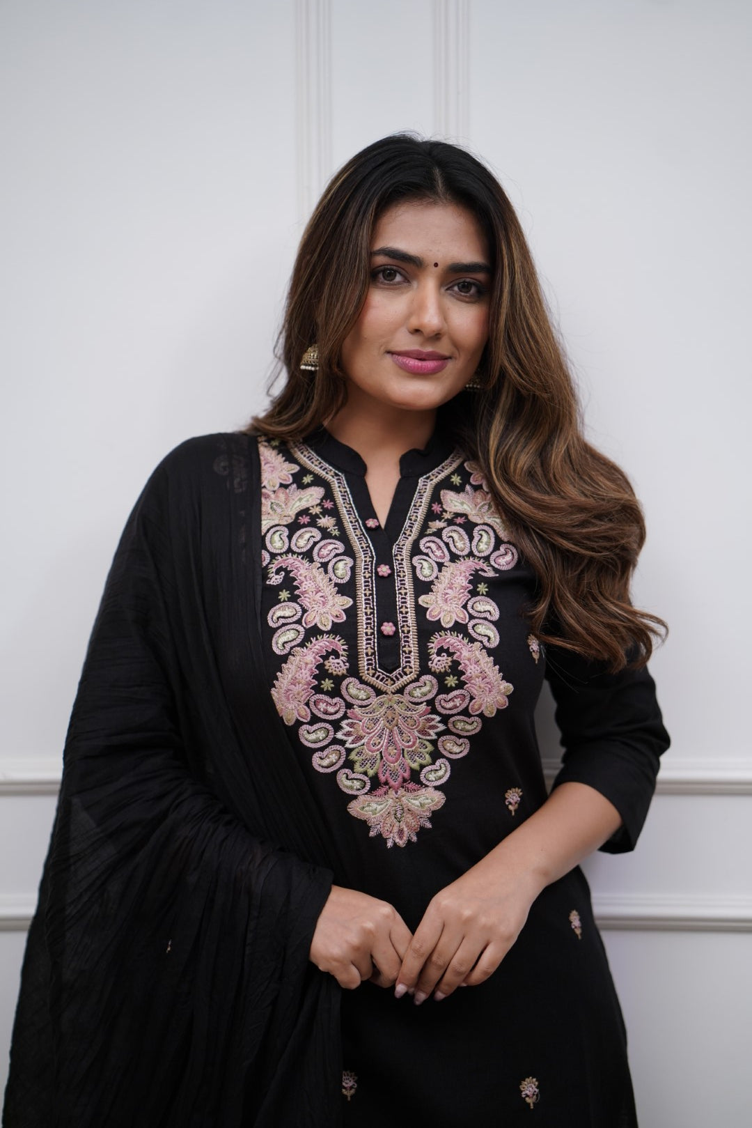 Make a bold statement with this classic black kurti set, featuring intricate pastel embroidery and a matching dupatta