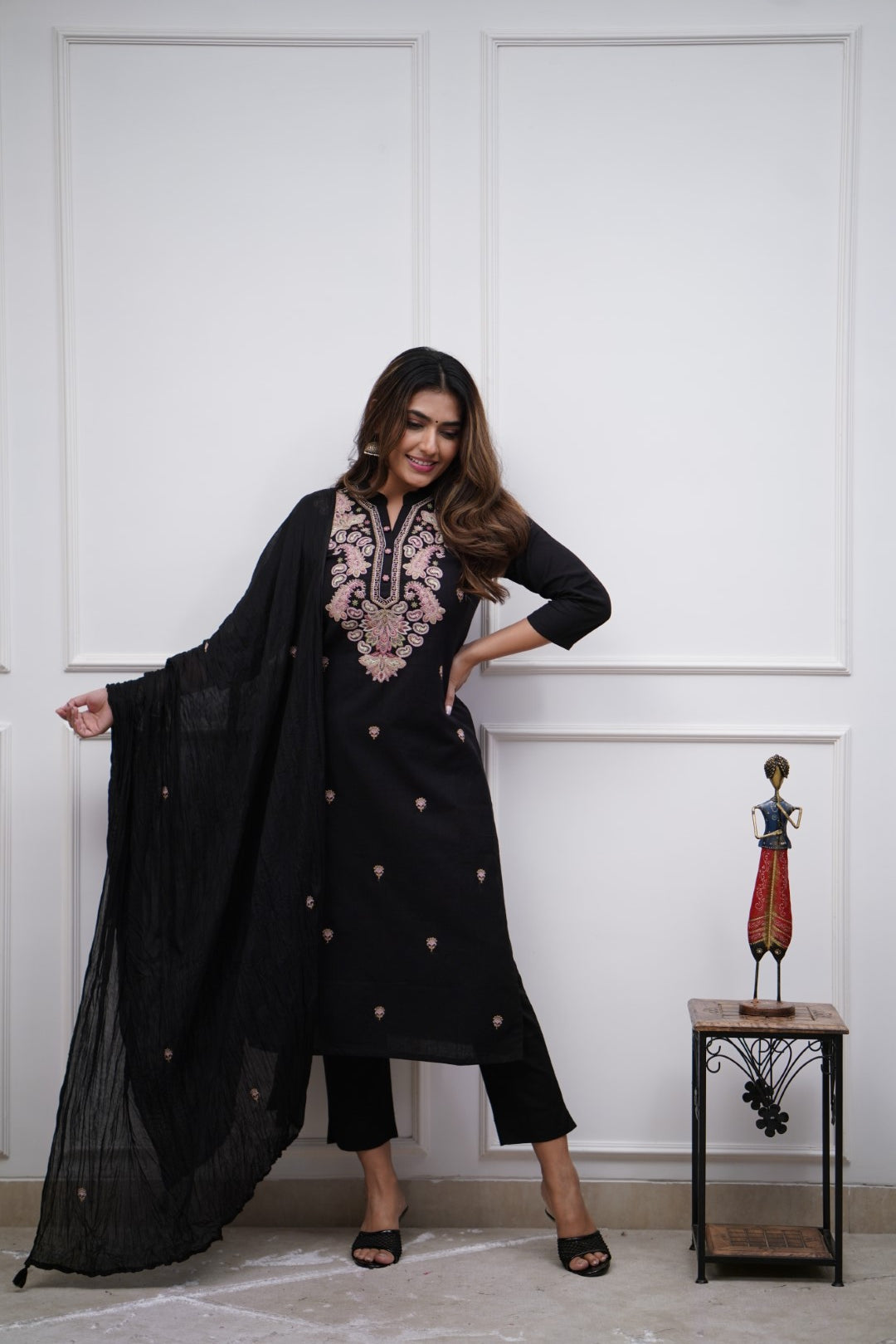 Make a bold statement with this classic black kurti set, featuring intricate pastel embroidery and a matching dupatta