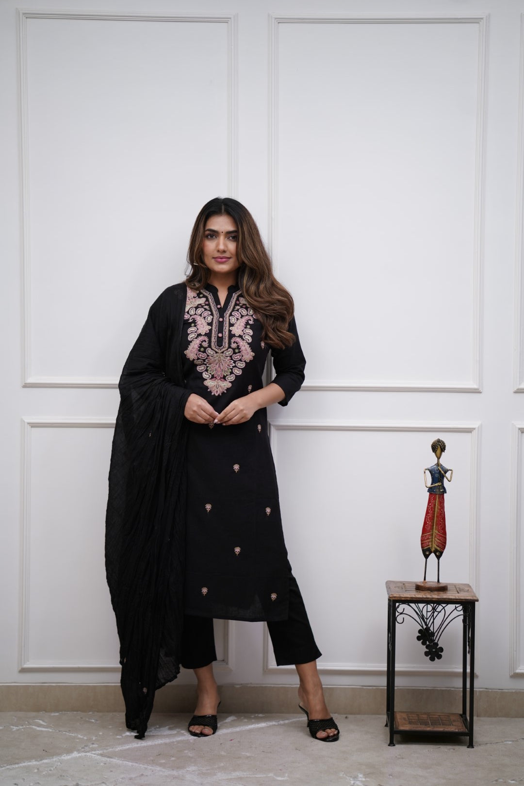 Make a bold statement with this classic black kurti set, featuring intricate pastel embroidery and a matching dupatta