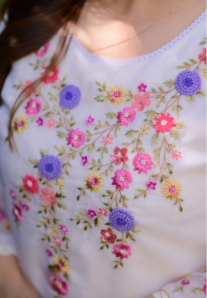 Radiate grace in this white floral embroidered kurti set, featuring delicate pastel blooms and a soft, flowy silhouette