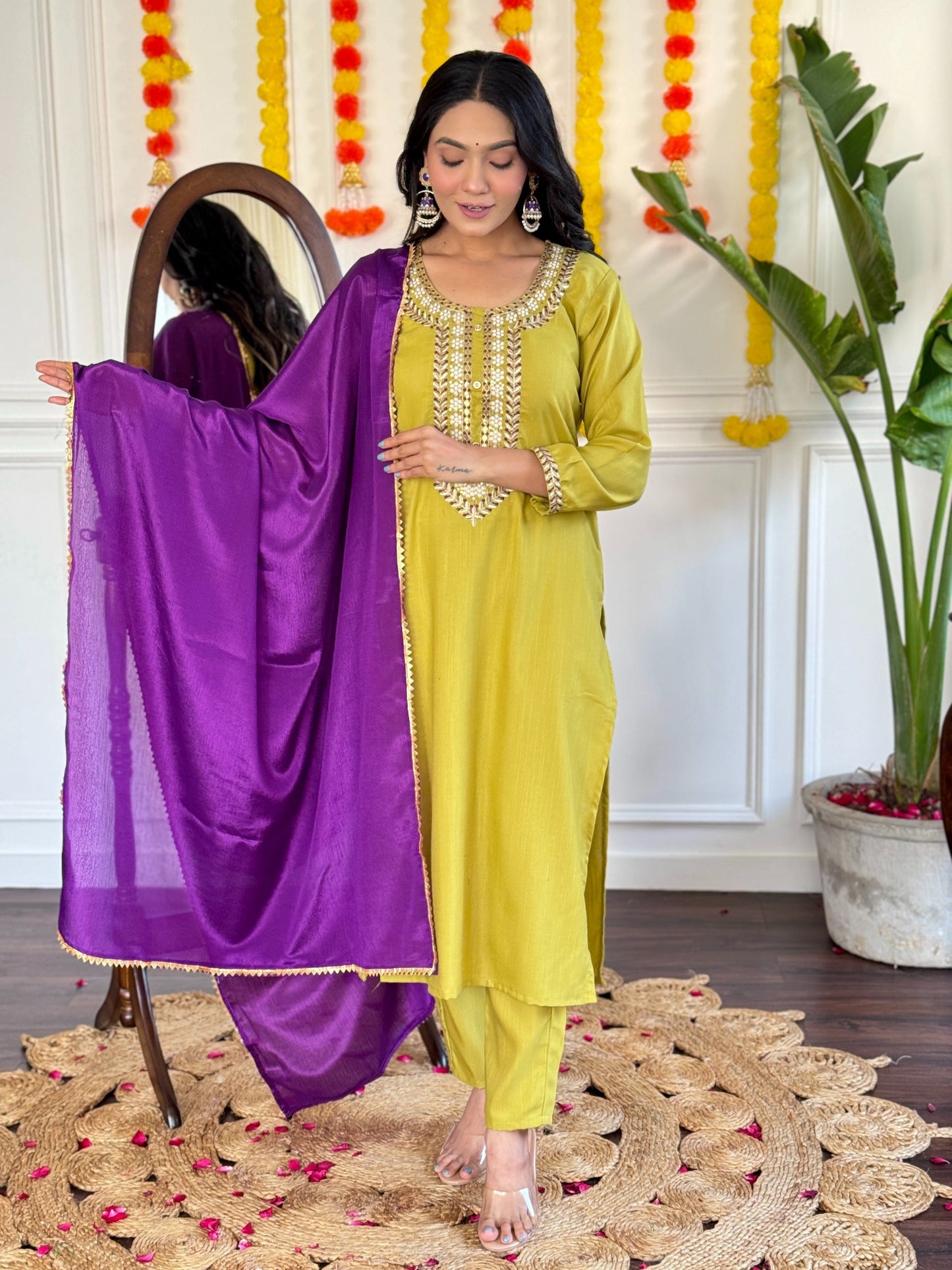 Radiate elegance in this mustard Kurti set, beautifully adorned with intricate mirror work and paired with a rich purple dupatta