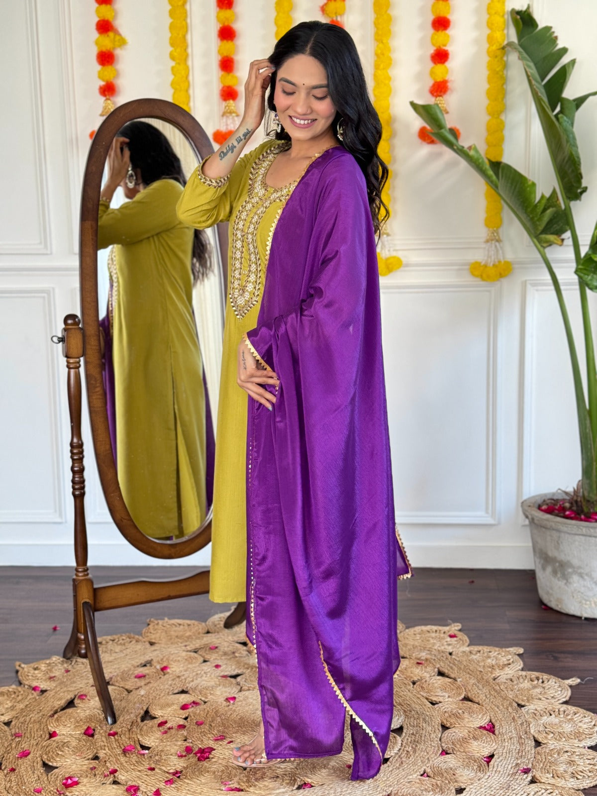 Radiate elegance in this mustard Kurti set, beautifully adorned with intricate mirror work and paired with a rich purple dupatta
