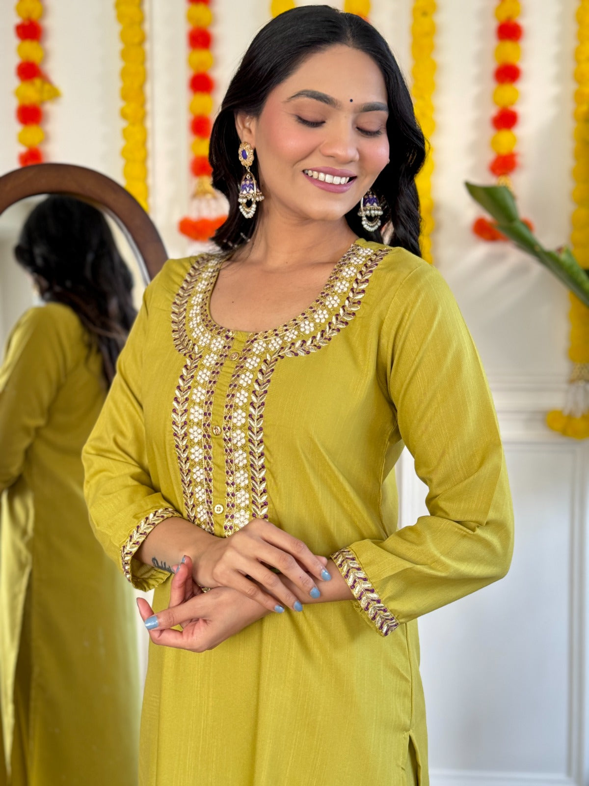 Radiate elegance in this mustard Kurti set, beautifully adorned with intricate mirror work and paired with a rich purple dupatta