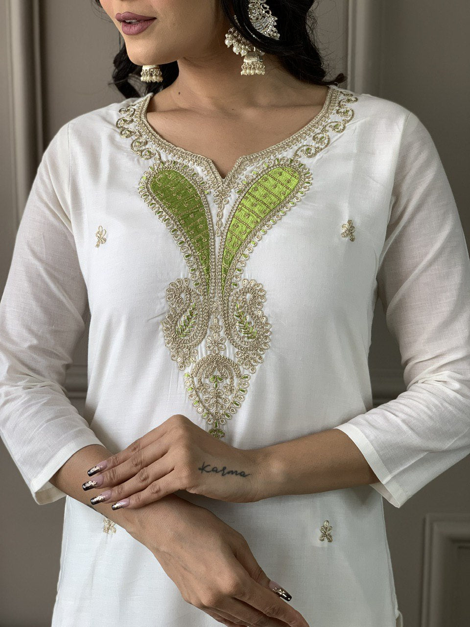 Exude grace in this pristine white Kurti set, adorned with delicate embroidery and paired with an elegant green dupatta