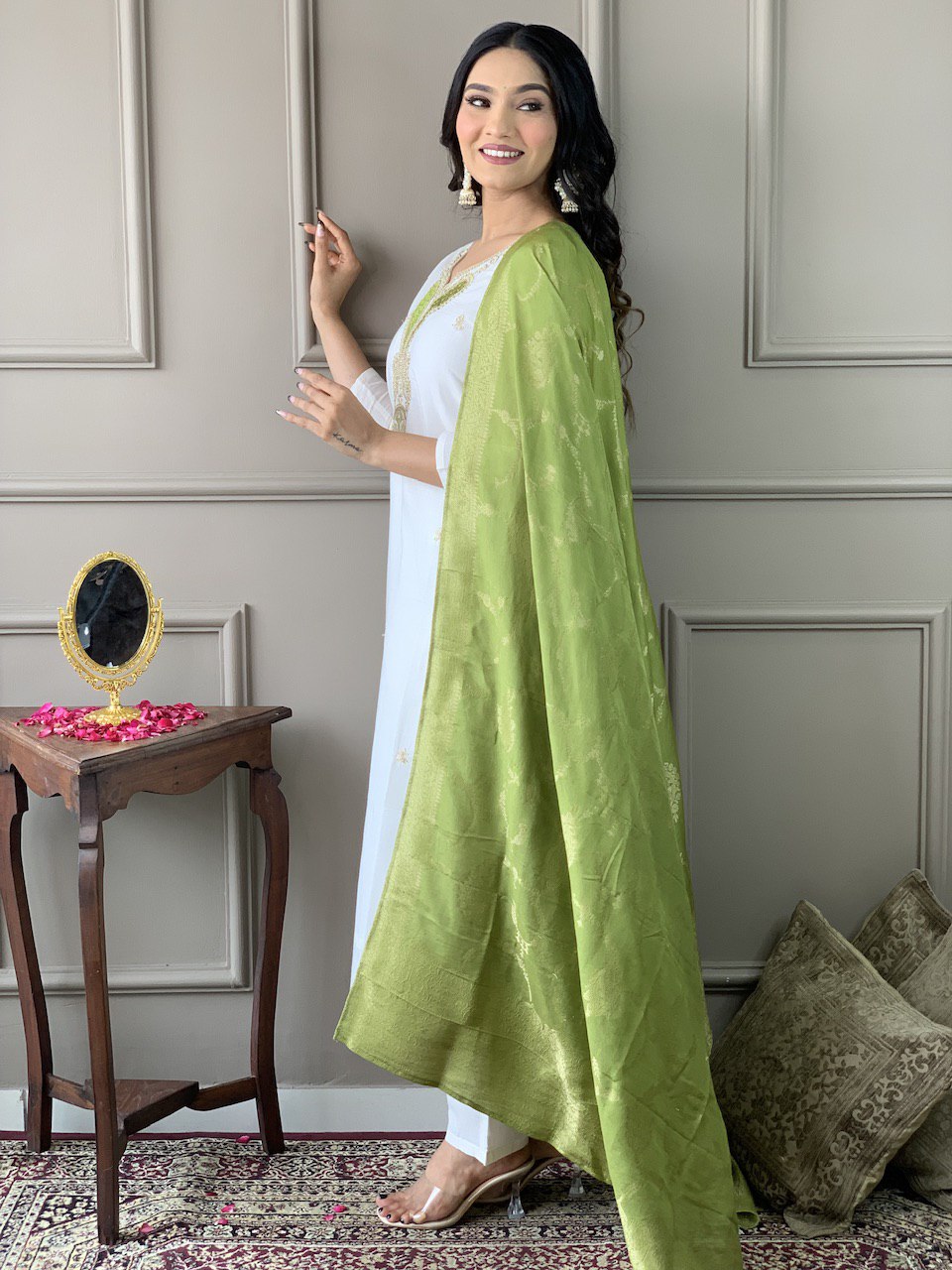 Exude grace in this pristine white Kurti set, adorned with delicate embroidery and paired with an elegant green dupatta