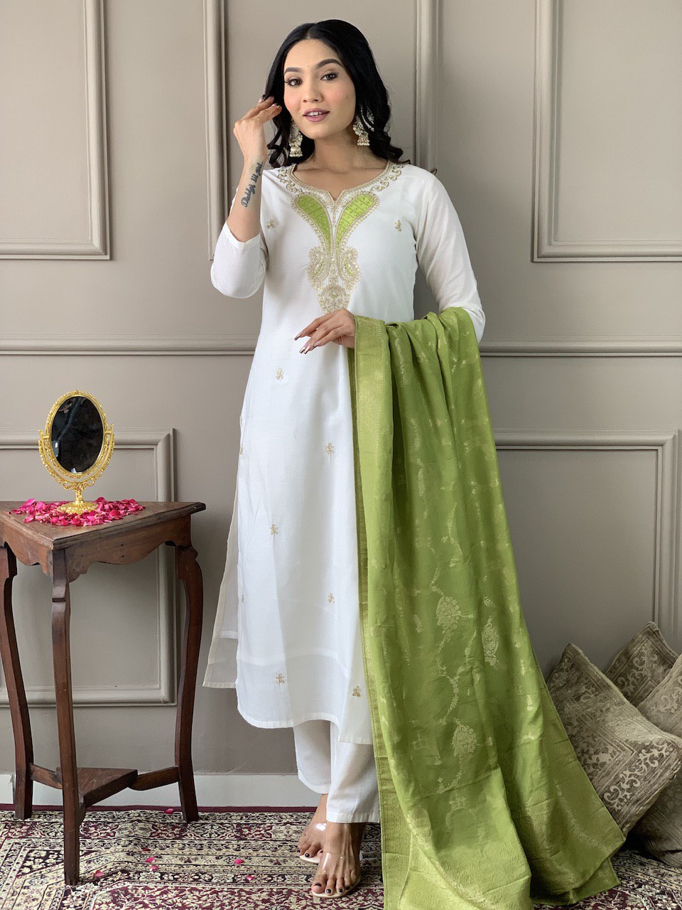 Exude grace in this pristine white Kurti set, adorned with delicate embroidery and paired with an elegant green dupatta