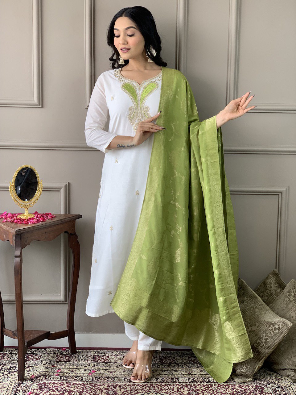 Exude grace in this pristine white Kurti set, adorned with delicate embroidery and paired with an elegant green dupatta