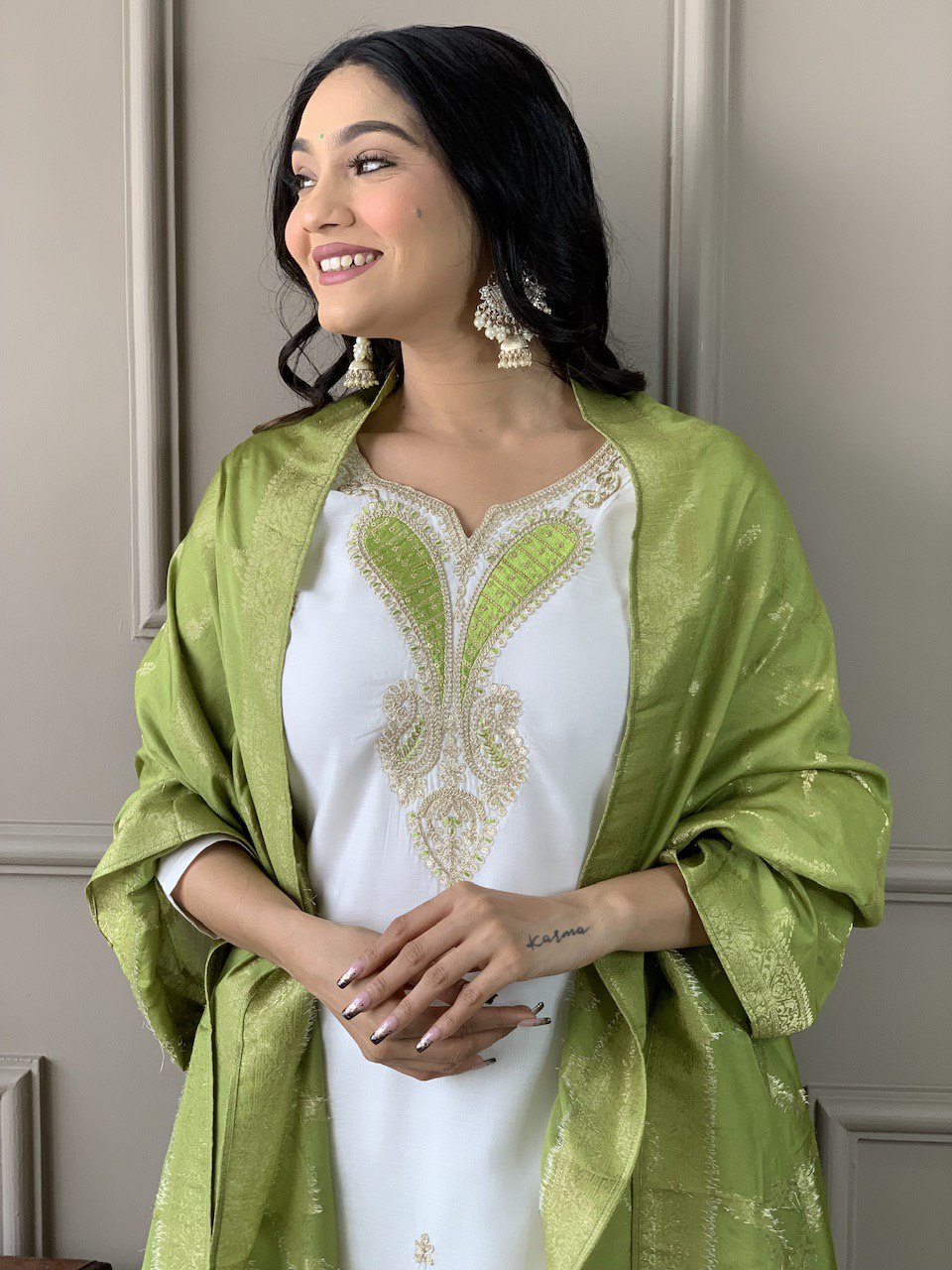 Exude grace in this pristine white Kurti set, adorned with delicate embroidery and paired with an elegant green dupatta