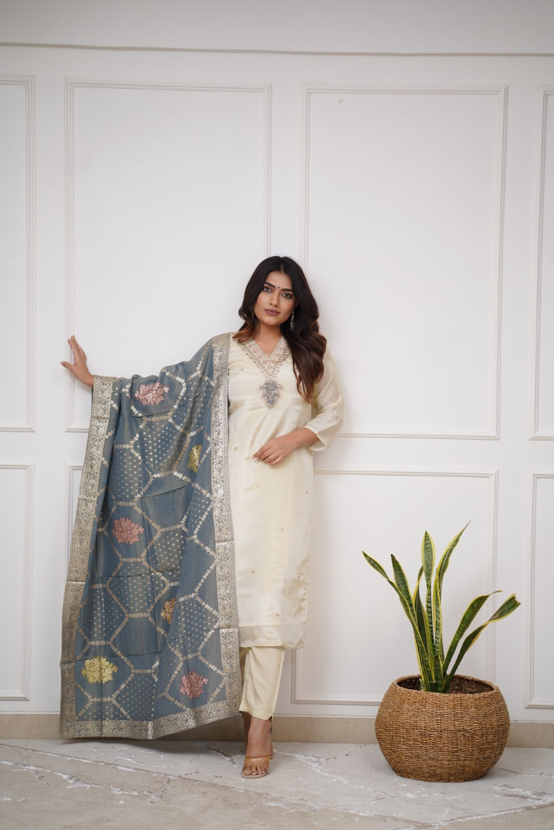Embrace timeless elegance with this ivory kurti set, featuring delicate embellishments and a regal blue dupatta with intricate gold detailing