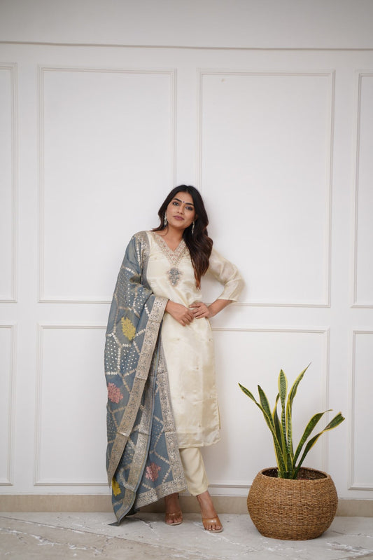 Embrace timeless elegance with this ivory kurti set, featuring delicate embellishments and a regal blue dupatta with intricate gold detailing